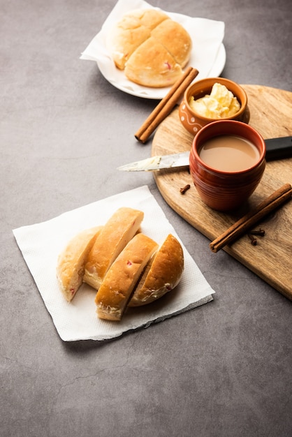 Bun-maska Tea or bun Maska chai combo features a slightly sweet bun studded with raisins that is cut into half and laden with wholesome butter, Mumbai food