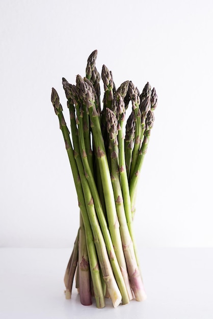 Bunch of asparagus on white table healthy vegan food