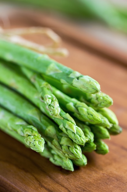 Bunch of Asparagus on  wooden chopping board