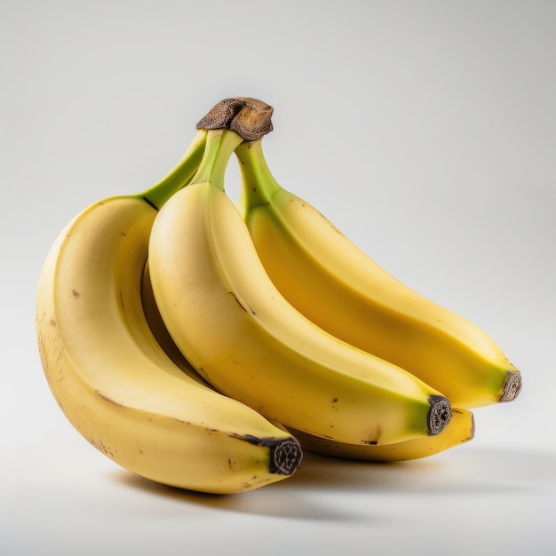 A bunch of bananas are sitting on a white surface.