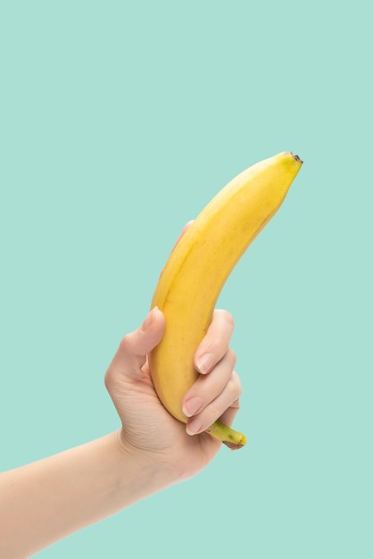 A bunch of bananas in woman hand isolated on white background