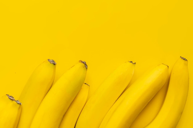 A bunch of bananas on yellow background isolated copy space design mockup b