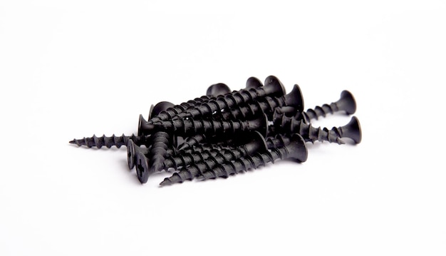 Bunch Of Black Metallic Screws Fastening Items Bolts Nuts Nails Closeup Photo On White Background