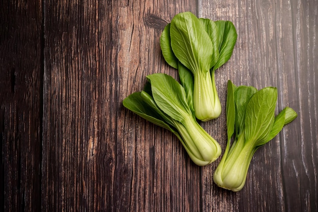 A bunch of bok choy on a wooden table