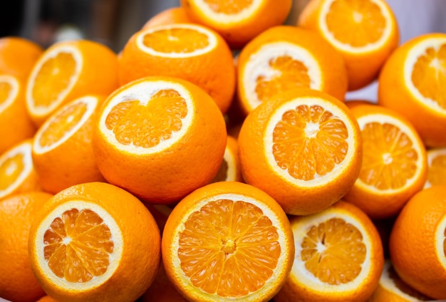 Bunch of bright color oranges on market stall as ripe juicy tropical fruit