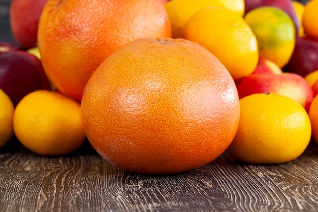 A bunch of citrus tangerines and other fruits together