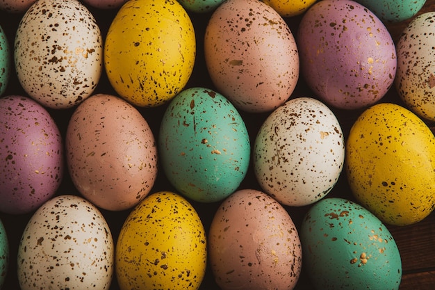 A bunch of colorful easter eggs with the word easter on the bottom