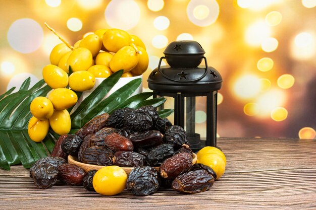 Bunch of different types of dates in bowls and plate with lantern. Selective focus points.