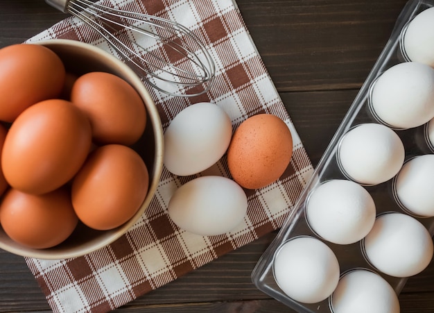 A bunch of eggs in a bowl and a napkin