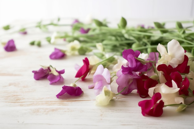 A bunch of flowers on a table with the word pea on it