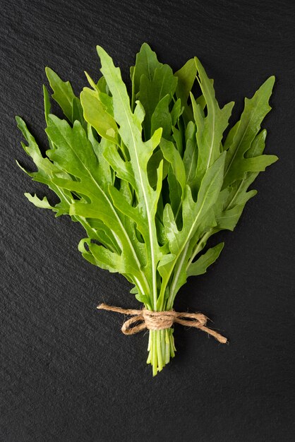 A bunch of fresh arugula on slate