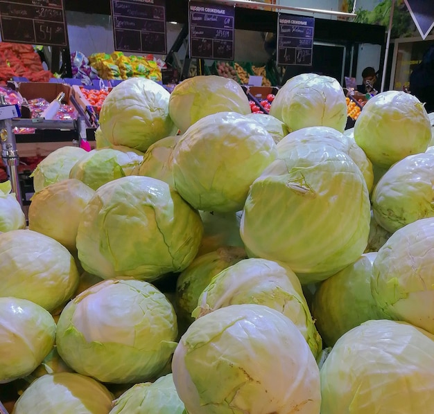 Bunch of fresh cabbages on display at a grocery store