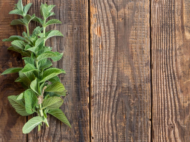 A bunch of fresh mint on a wooden table Healthy food concept