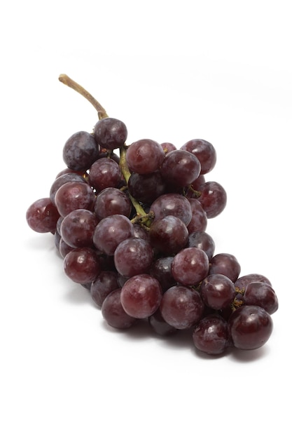 A bunch of fresh organic red grapes delicious fruit side view isolated on white background