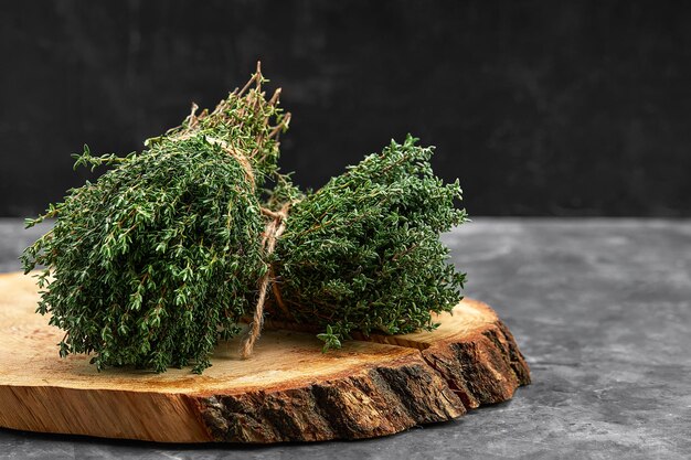 Bunch of fresh thyme herb on old wooden board