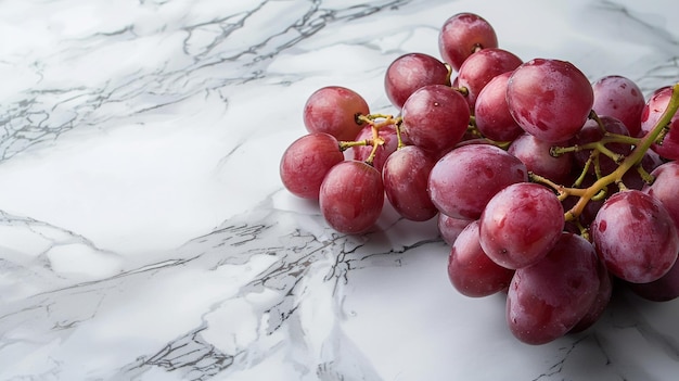 a bunch of grapes are on a marble surface