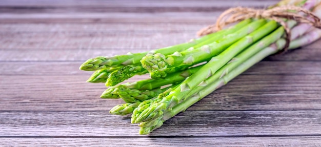 Bunch of green asparagus on gray background Organic vegetables for health