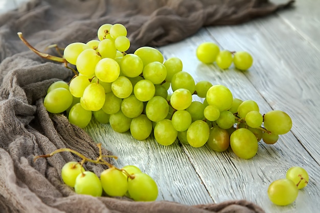 Bunch green grapes on a grey wooden background