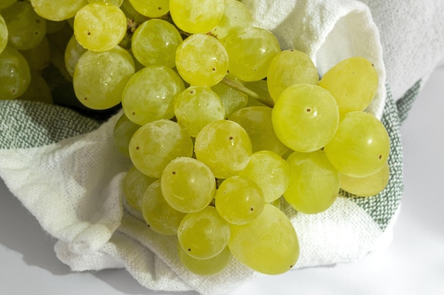 Bunch of green grapes on white background