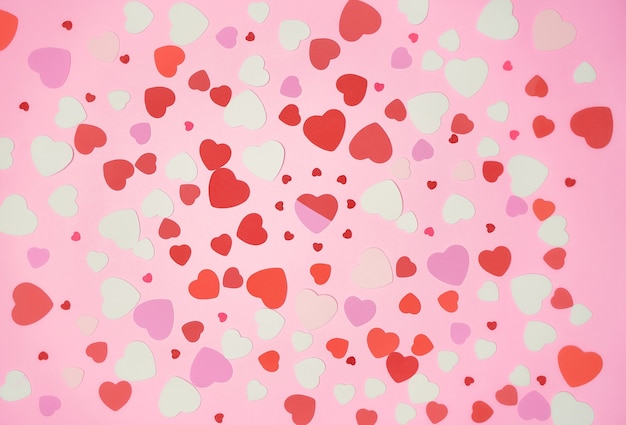 Bunch of hearts spread in a pink background, flat lay