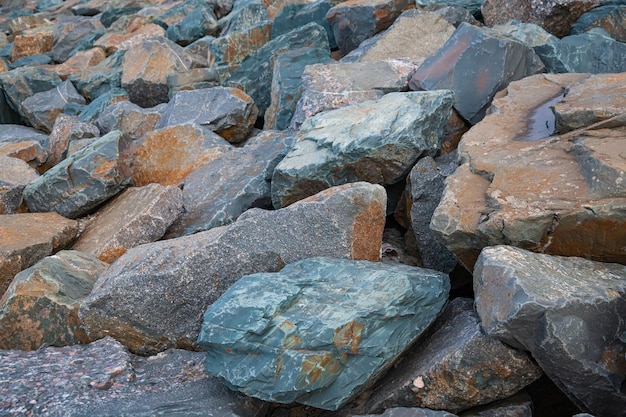 A bunch of huge multicolored stones lie next to each other