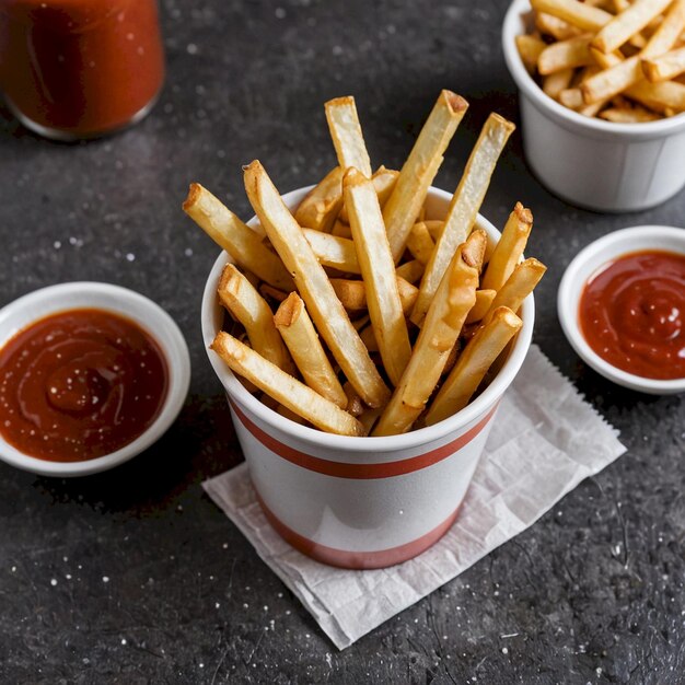 a bunch of ketchup and french fries are on a table