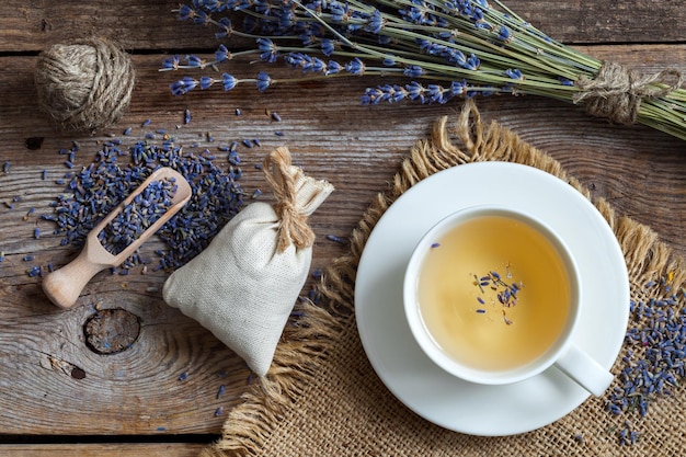 Bunch of lavender flowers sachets filled with dried lavender and healthy tea Top view Flat lay