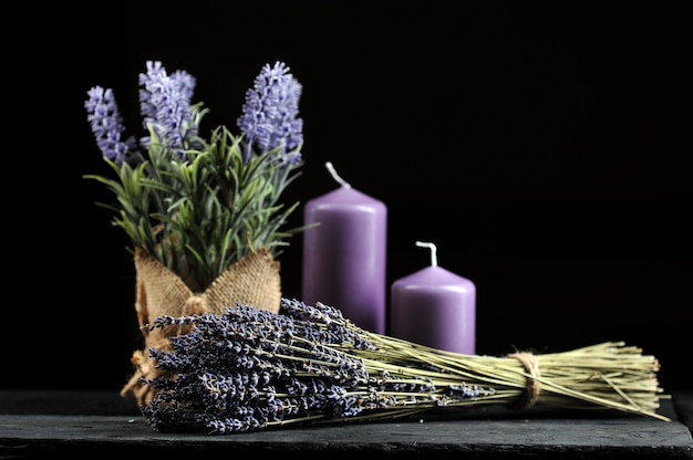 Bunch of lavender tied with twine and aromatic lilac candles