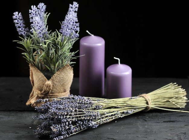 Bunch of lavender tied with twine and aromatic lilac candles