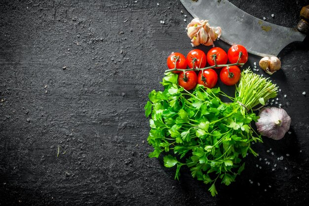 Bunch of parsley with cherry tomatoes and garlic cloves