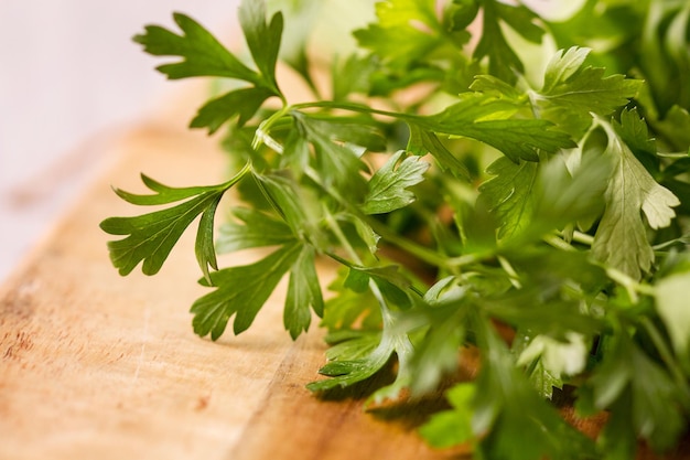 A bunch of parsley on a wooden table in a close up view