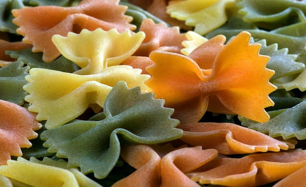 A bunch of pasta is on a table with other things.