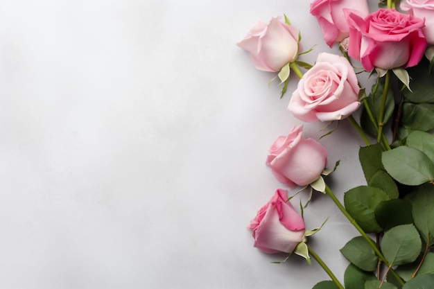 a bunch of pink roses sitting on top of a white surface