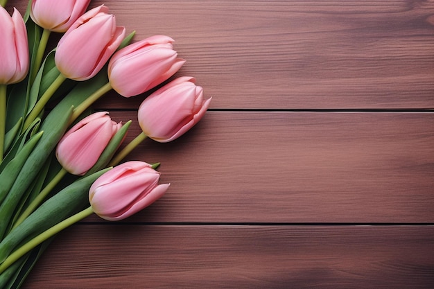 A bunch of pink tulips on a wooden background