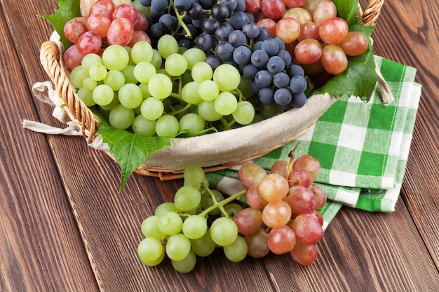 Bunch of red purple and white grapes in basket