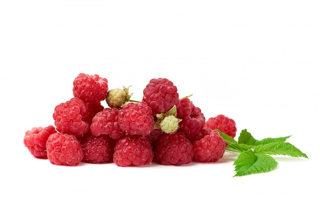 Bunch of red ripe raspberries and green leaf