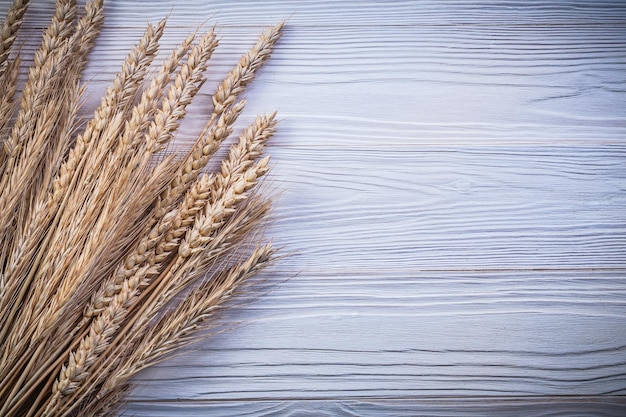 Bunch of ripe wheat rye ears on wooden board food and drink concept