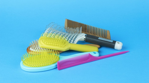 A bunch of a set of combs on a light blue background