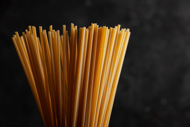 Bunch of spaghetti pasta on dark concrete background