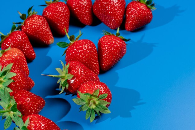 Bunch of strawberries on blue wall