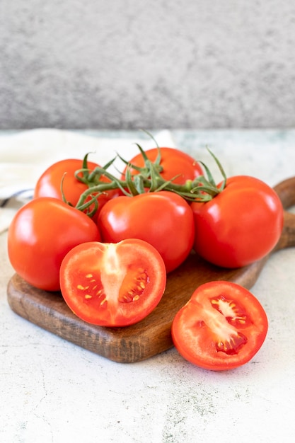 Bunch tomatoesFresh tomatoes on stone floor Organic food close up