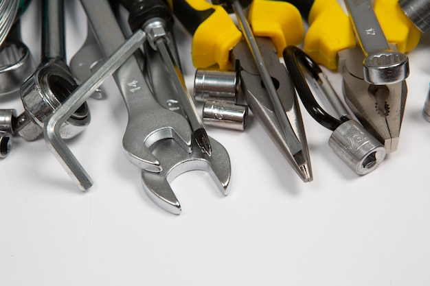 A bunch of tools including a wrench, one of which is yellow and the other has a silver tip.