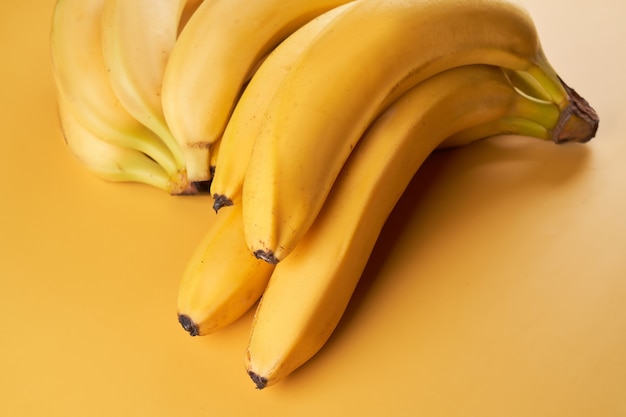 Bunch of whole bananas isolated on yellow 