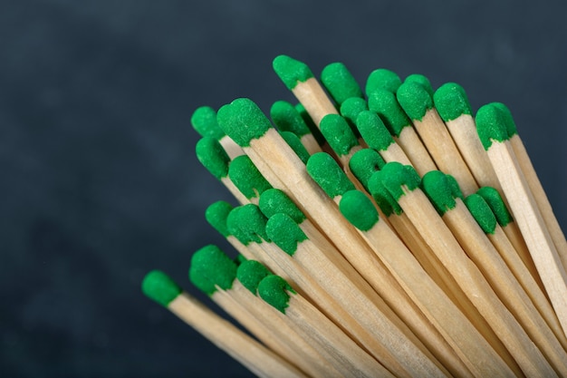 A bunch of wooden matches with green gray