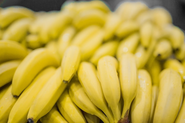 Bunch of yellow bananas in supermarket Fresh and healthy Shallow depth of field