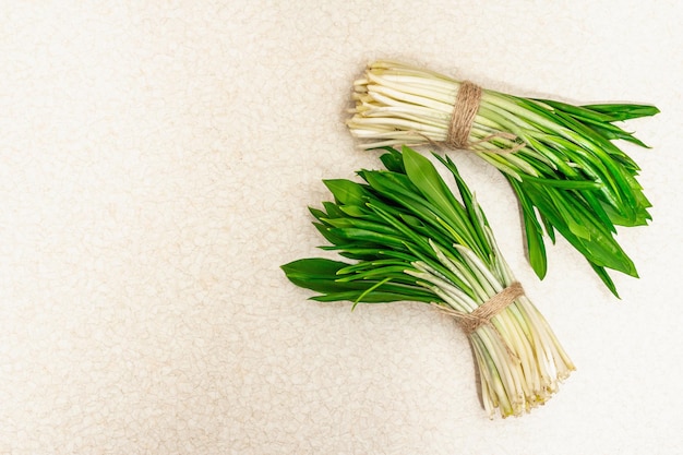 Bunches of fresh harvest of spring ramson wild leek Fragrant spicy leaves on vintage wooden table