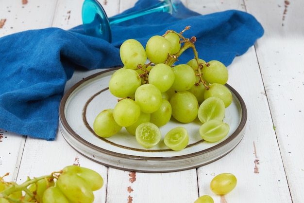 Bunches of fresh ripe green grapes on a wooden table