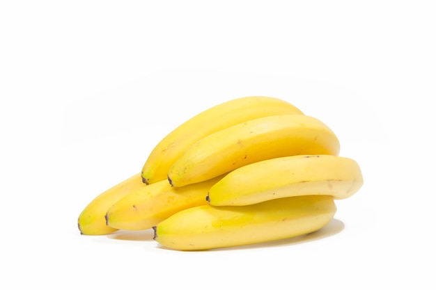 Bunches of yellow bananas lie on a white background isolated