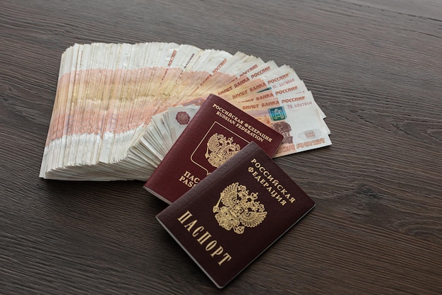 A bundle of five thousand Russian rubles is spread out on the table There are passports 5000