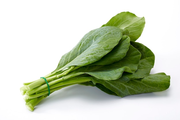 Bundle of water drops on fresh Chinese kale vegetable on white background